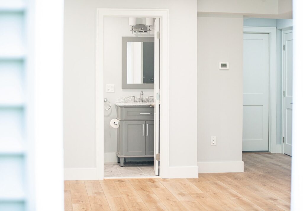 Bathroom Remodeling - River City Construction Modern bathroom design with a luxurious marble countertop and striking black and white tile, ideal for a remodel project by river city construction Medford bathroom remodel expert team.
