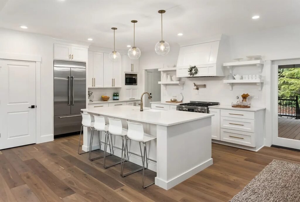 A spacious white kitchen featuring a central island, showcasing a modern remodel in Medford.